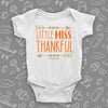 Cute baby girl onesies with saying "Little Miss Thankful" in white. 