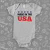 Cool baby onesie with saying "Made In The USA" in grey.