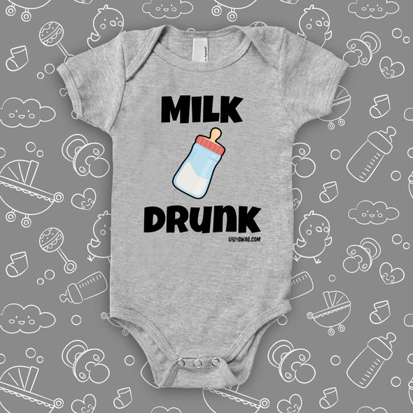 Grey hilarious baby onesie with "Milk drunk" saying and an image of a baby bottle.