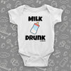 White, hilarious baby onesie with "Milk drunk" saying and an image of a baby bottle.