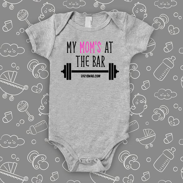 Cool baby onesies with saying: "Mom's At The Bar" in grey.