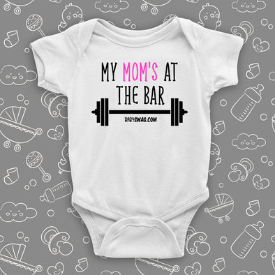 Cool baby onesies with saying: "Mom's At The Bar" in white. 