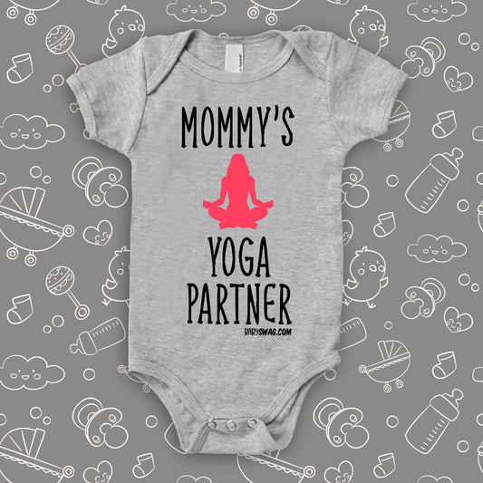 Cute baby onesies with saying "Mommy's Yoga Partner" in grey.