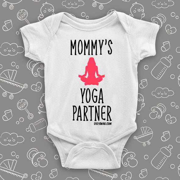 Cute baby onesies with saying "Mommy's Yoga Partner" in white.
