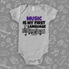 Cute baby onesies with saying "Music Is My First Language" in grey. 