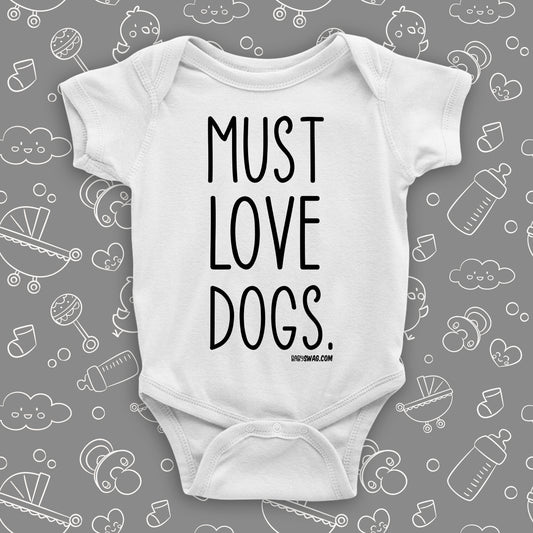 White cool baby onesie with print "Must love dogs."