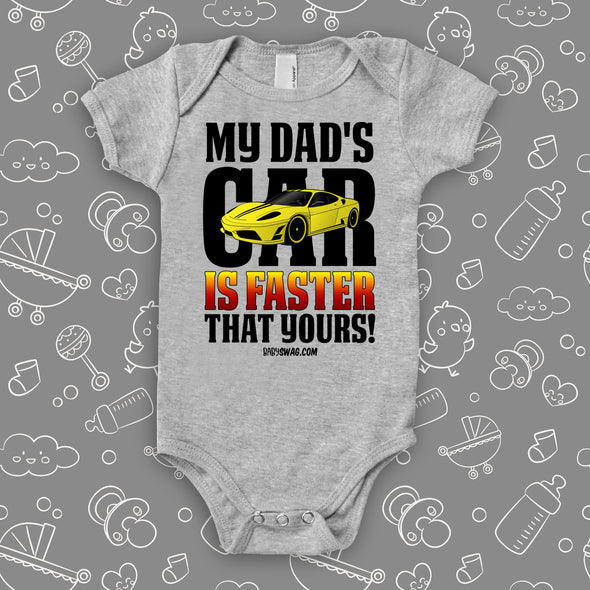 A grey cute baby boy onesie with saying "My Dad's Car Is Faster Than Yours!" and an image of a yellow race car.