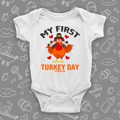 Cute baby onesies with saying "My First Turkey Day" and an image of a turkey in white.