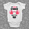 The ''My Mom Is Stronger Than Your Dad'' cool baby onesie in white