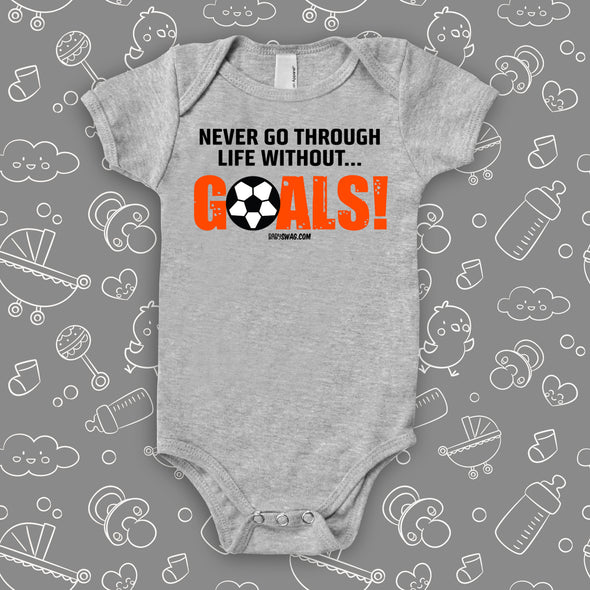 Unique baby onesies with saying "Never Go Through Life Without Goals!" in grey. 