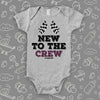 A grey baby boy onesie with "New To The Crew" print. 