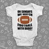 Cute baby boy onesies with saying: "On Sunday We Watch Foodball With Daddy" in white.