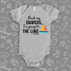 The ''Pack My Diapers, I'm Going To The Lake'' swag baby clothes in grey.