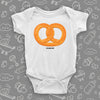 Cute baby onesie with an image of a pretzel, color white.