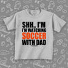 Toddler boy shirts with the caption "Shh..I'm Watching Soccer With Dad" in grey. 