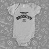 Cool baby onesies with saying "Spread Love, It's The Brooklyn Way" in grey. 