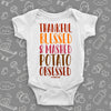  Funny baby onesies with saying "Thankful, Blessed & Mashed Potato Obsessed" in white.
