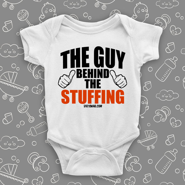 Funny baby onesies with saying "The Guy Behind The Stuffing" in white. 