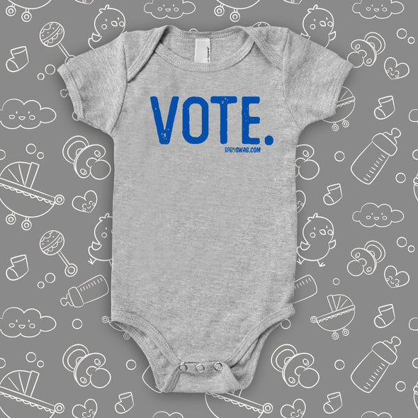Grey baby onesie with a "Vote." print.