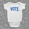 White baby onesie with a "Vote." print.