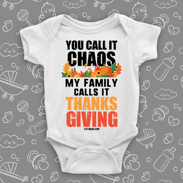 Funny baby onesie with saying "You Call Iy Chaos, My Family Calls It Thanksgiving" in white.